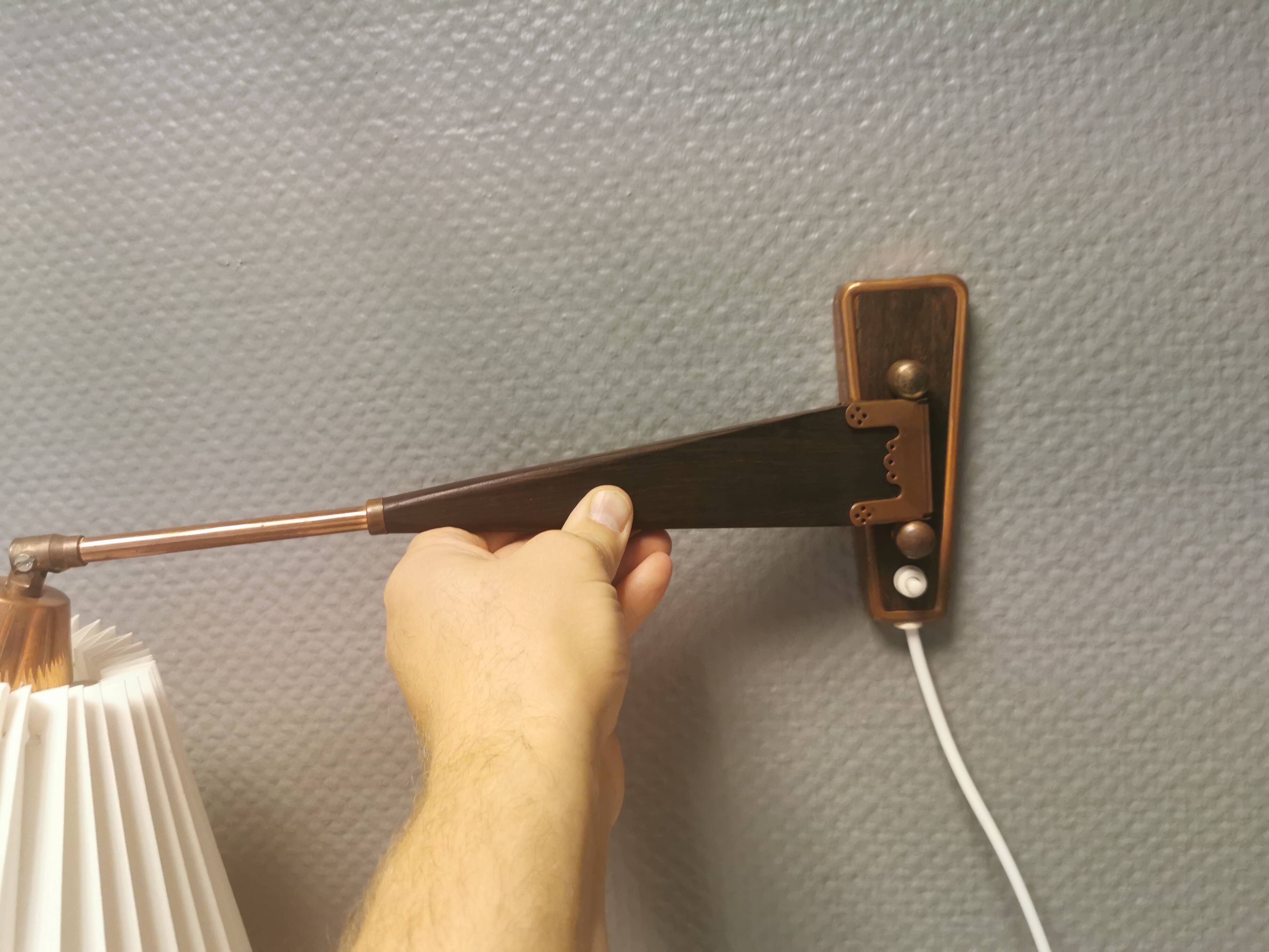 Wall lamp with adjustable ‘arm’ in copper and rosewood, with white shade.