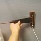 Wall lamp with adjustable ‘arm’ in copper and rosewood, with white shade.