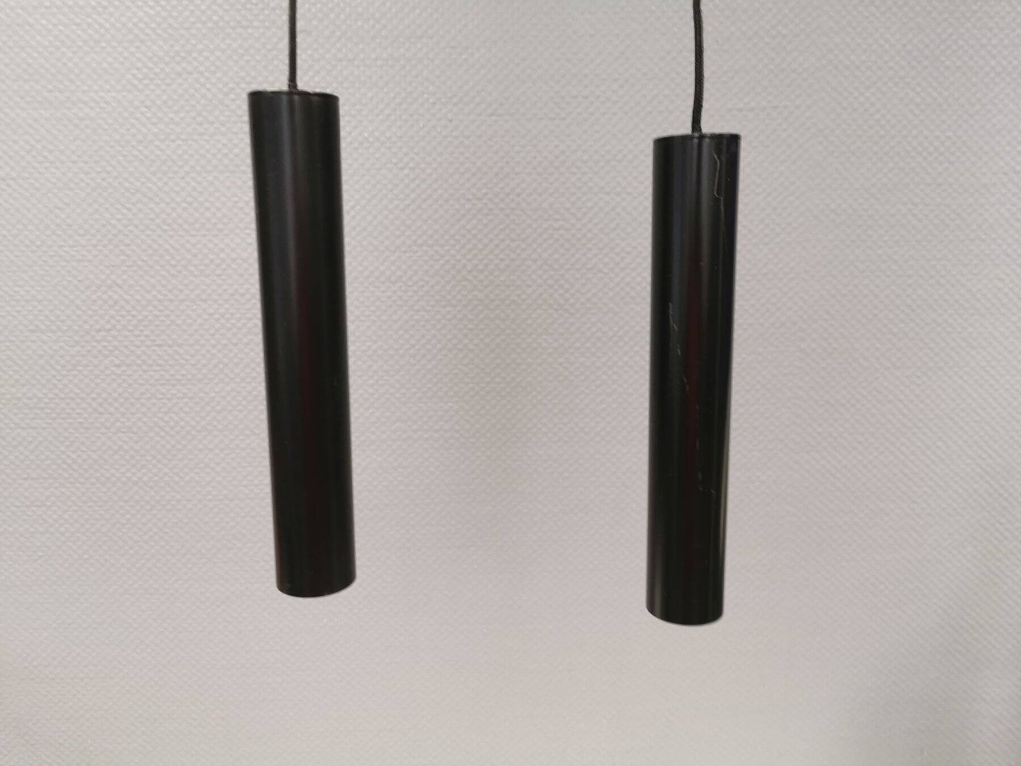 Two cylinder-shaped hanging lamps in black lacquer