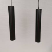 Two cylinder-shaped hanging lamps in black lacquer