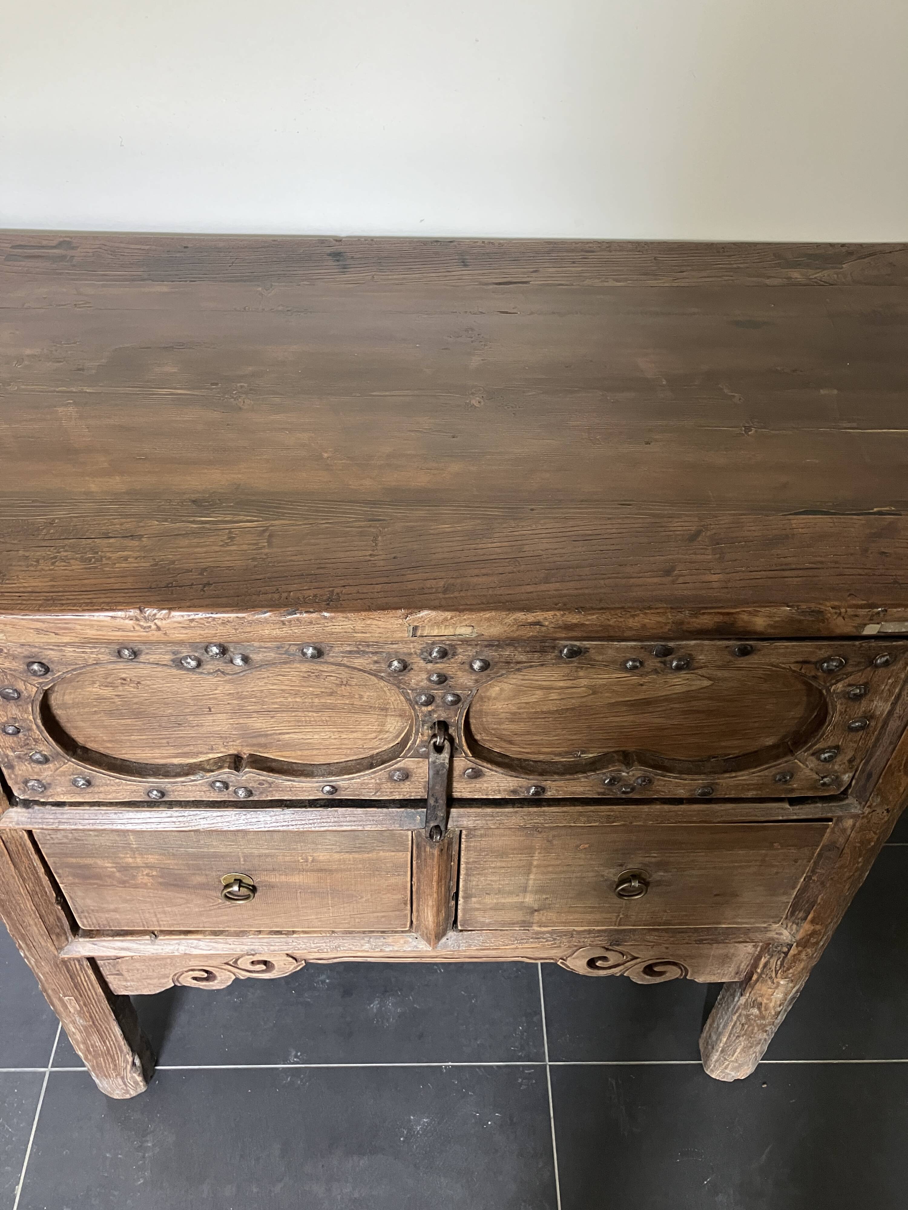 Very old elm wood with carved patterns and ironwork pieces.