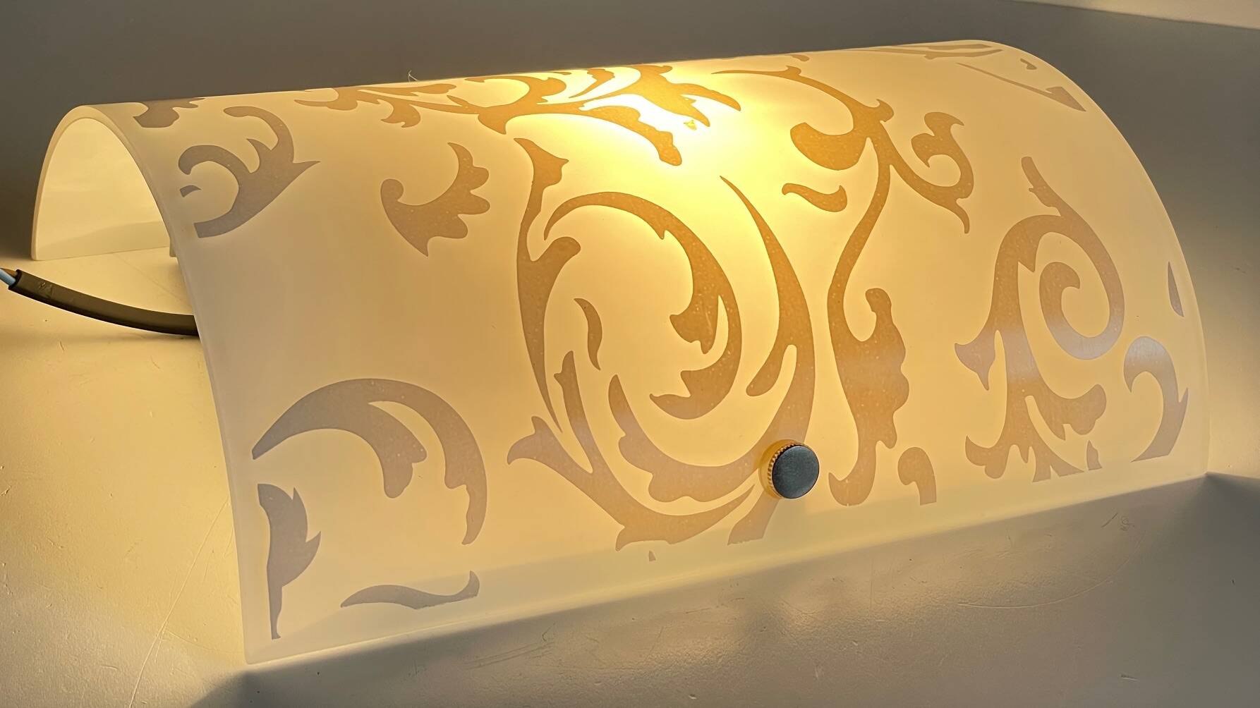Polished and screen-printed glass sconce by eglo