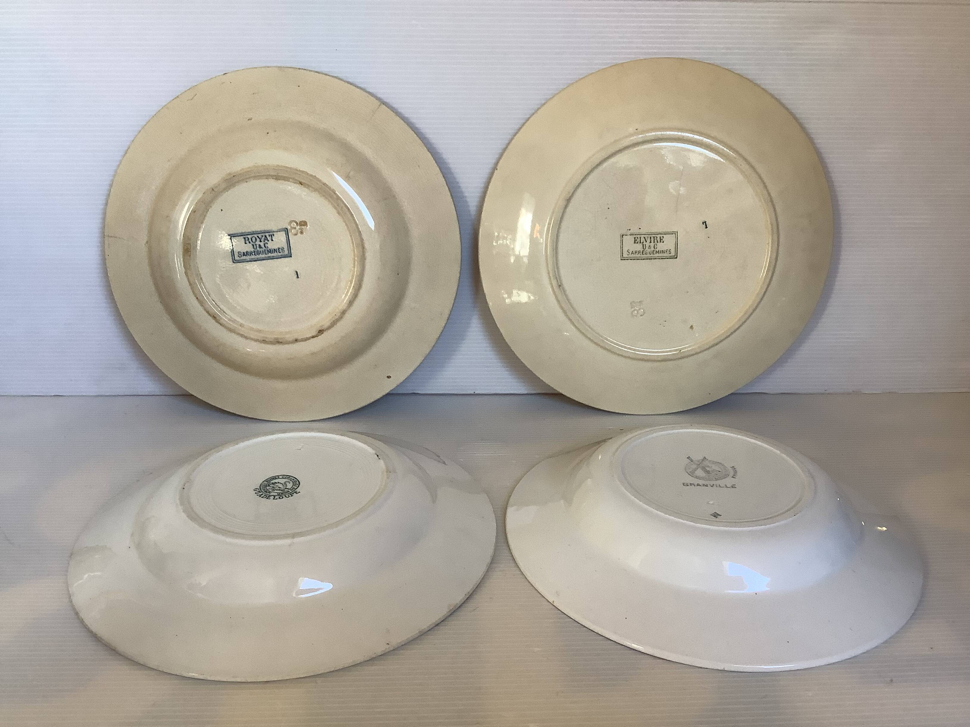 Four old earthenware plates