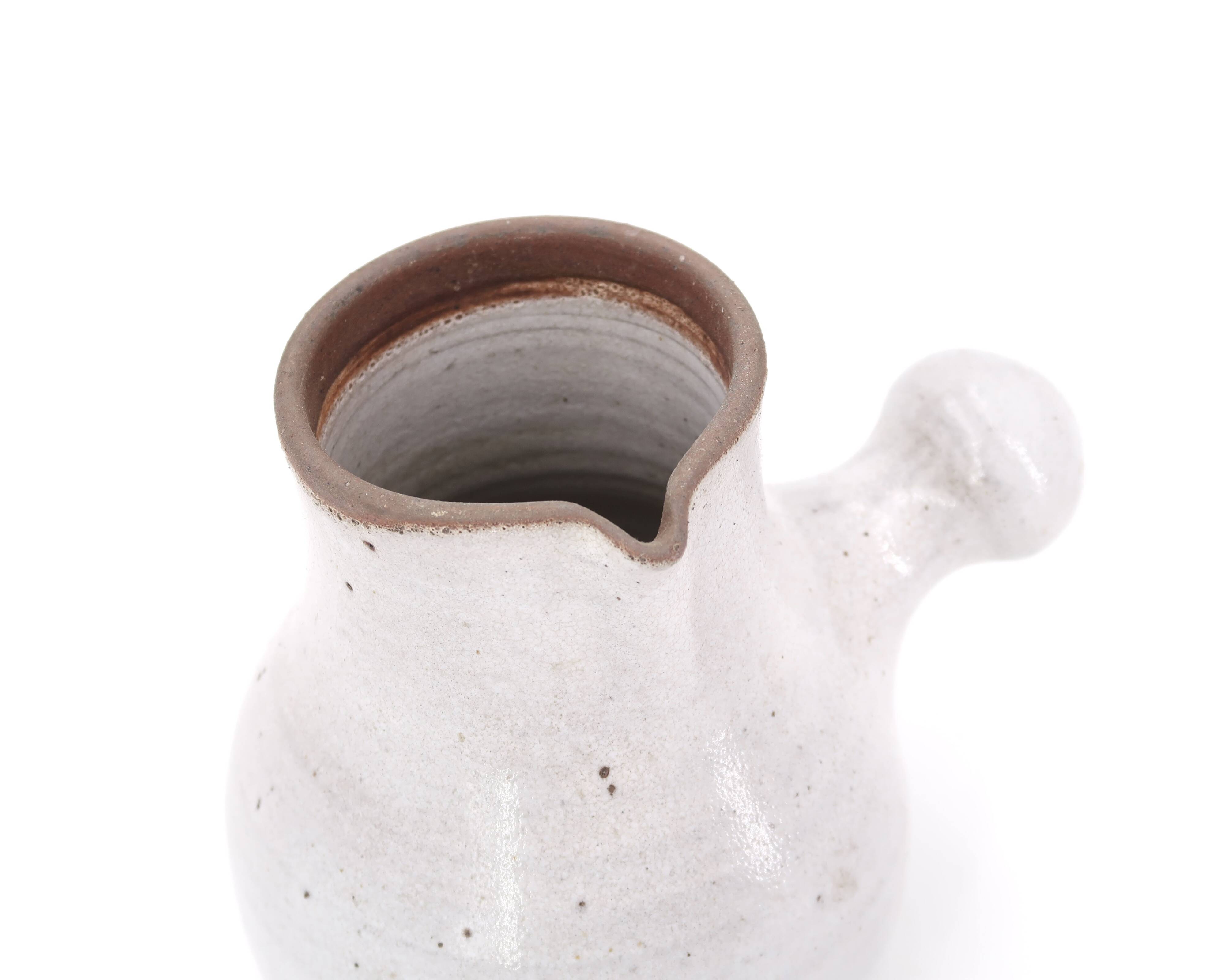 Minimalist white ceramic pitcher signed Pierlot, 1960s