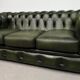 Three-seater green leather Chesterfield sofa