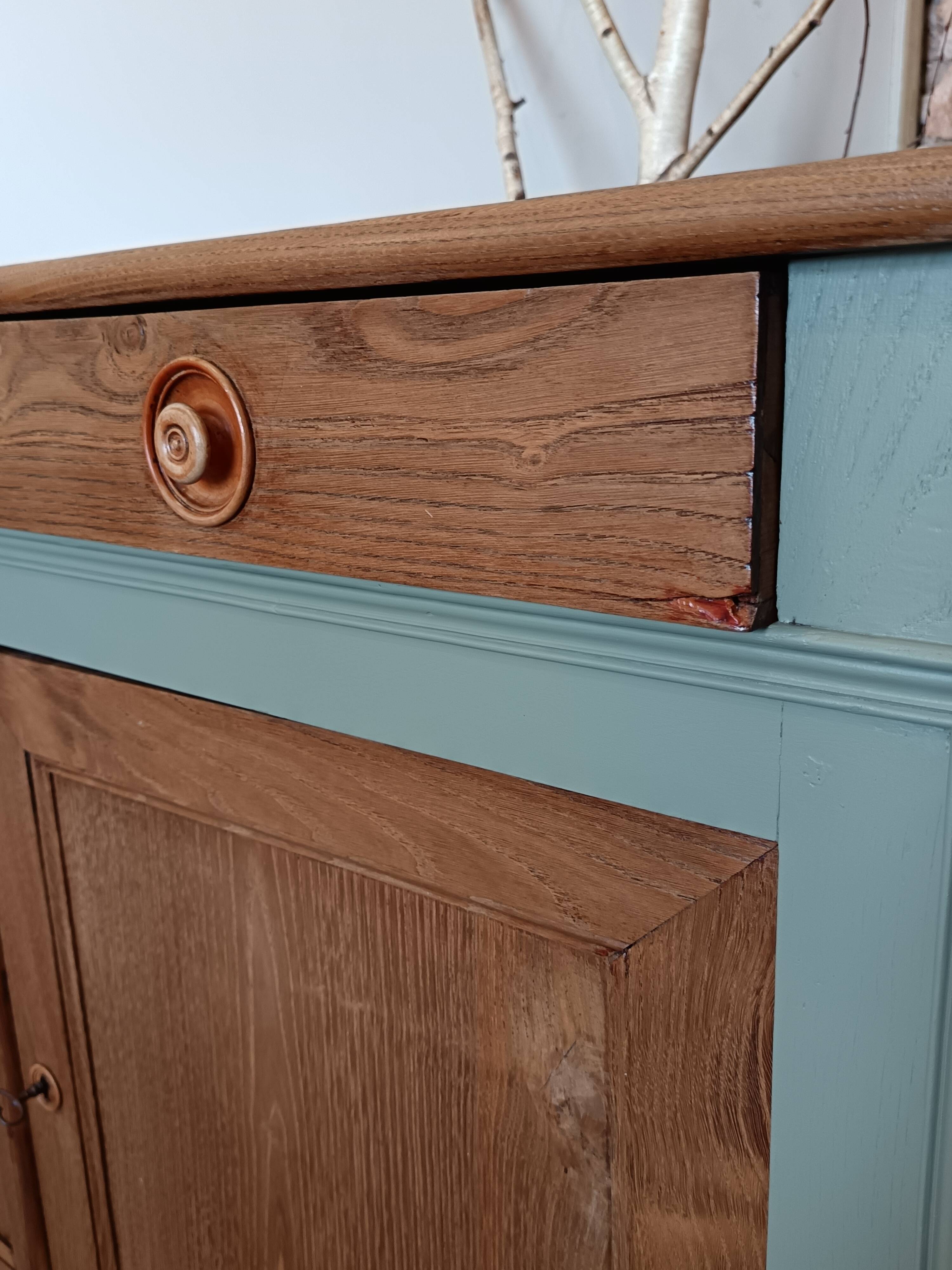 Buffet made of natural wood and bronze green.