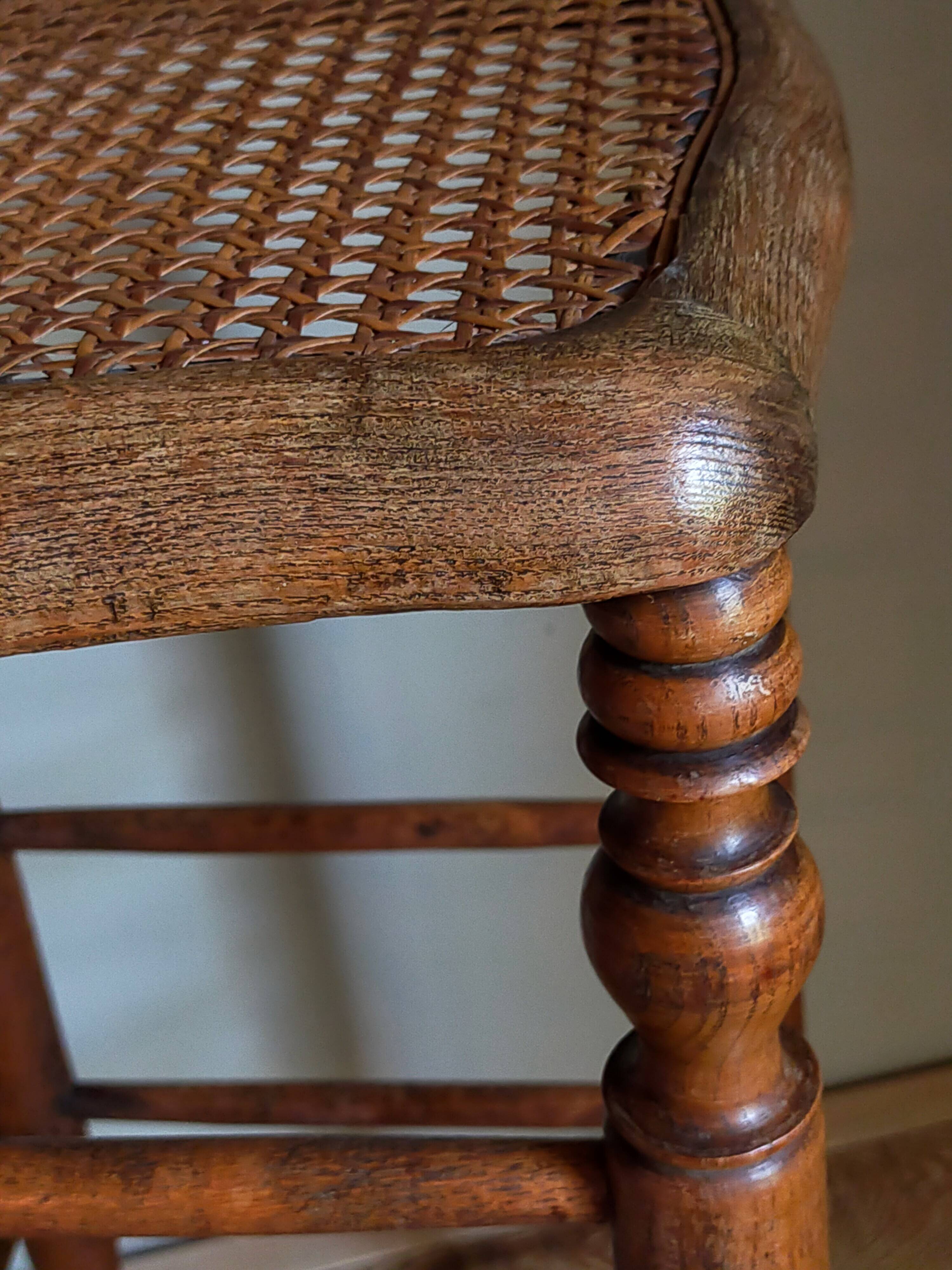 Antique stool with cane and turned wood