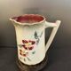 Antique pitcher in slipware with floral decoration – red and cream floral design