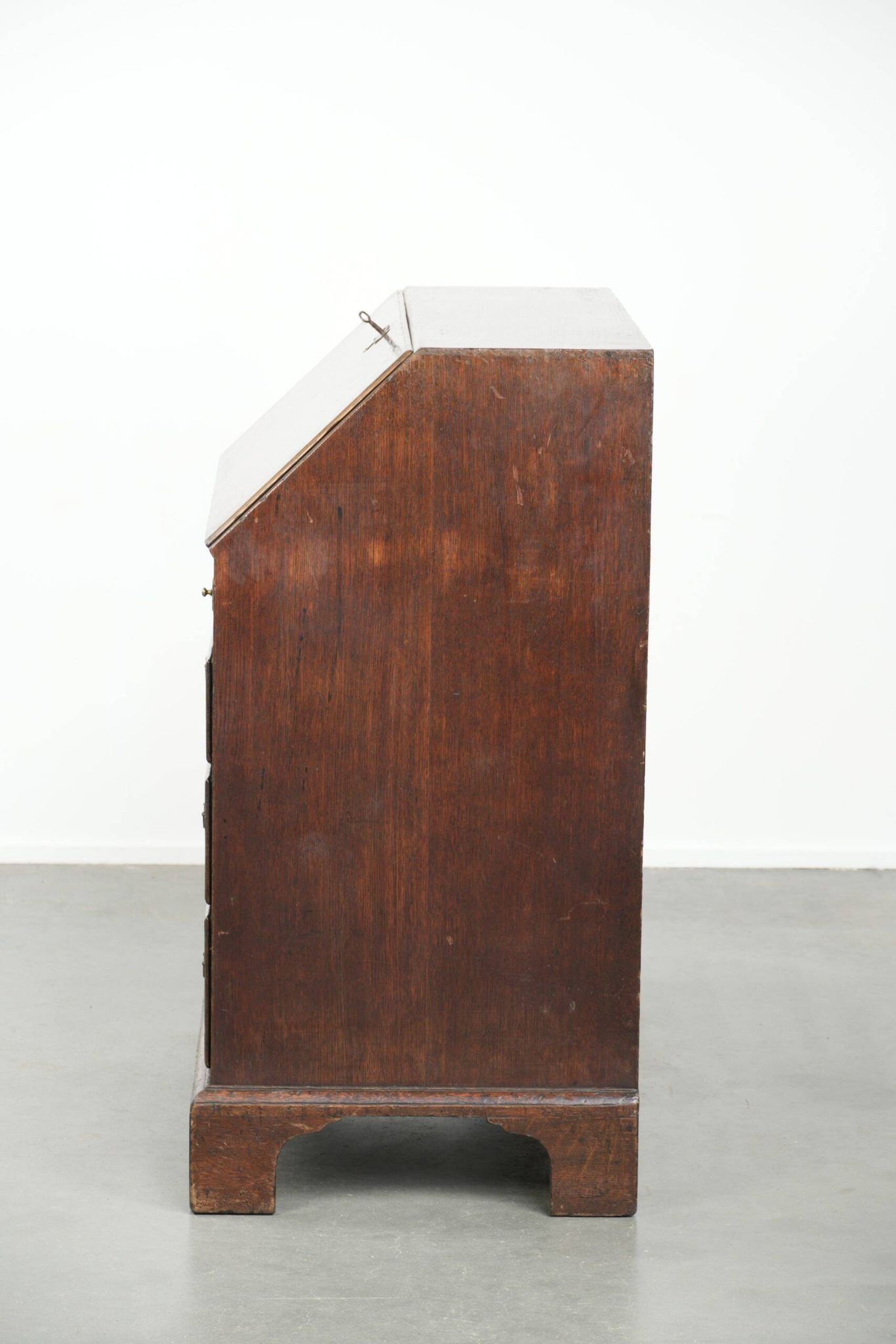 Antique English oak secretary from the 18th century with a stepped interior
