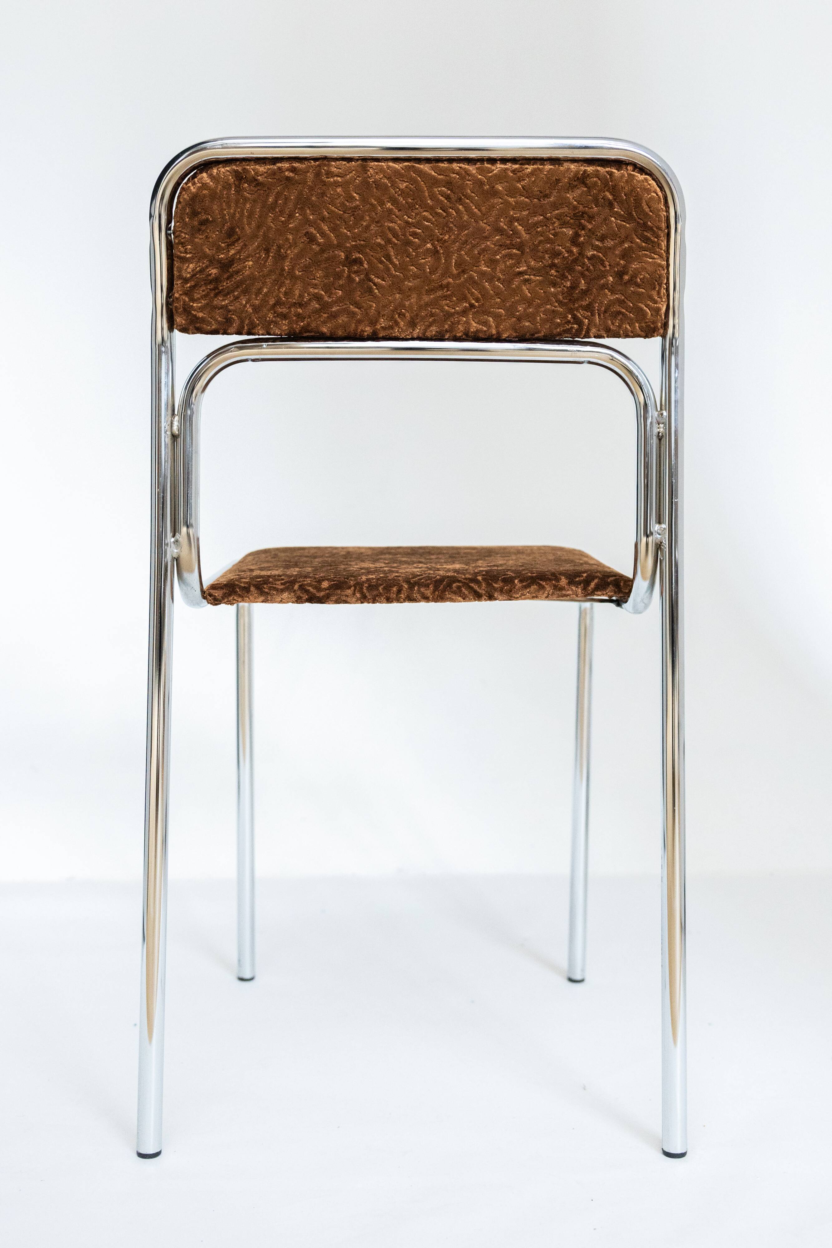 Chrome dining chair upholstered in brown bitten velvet.