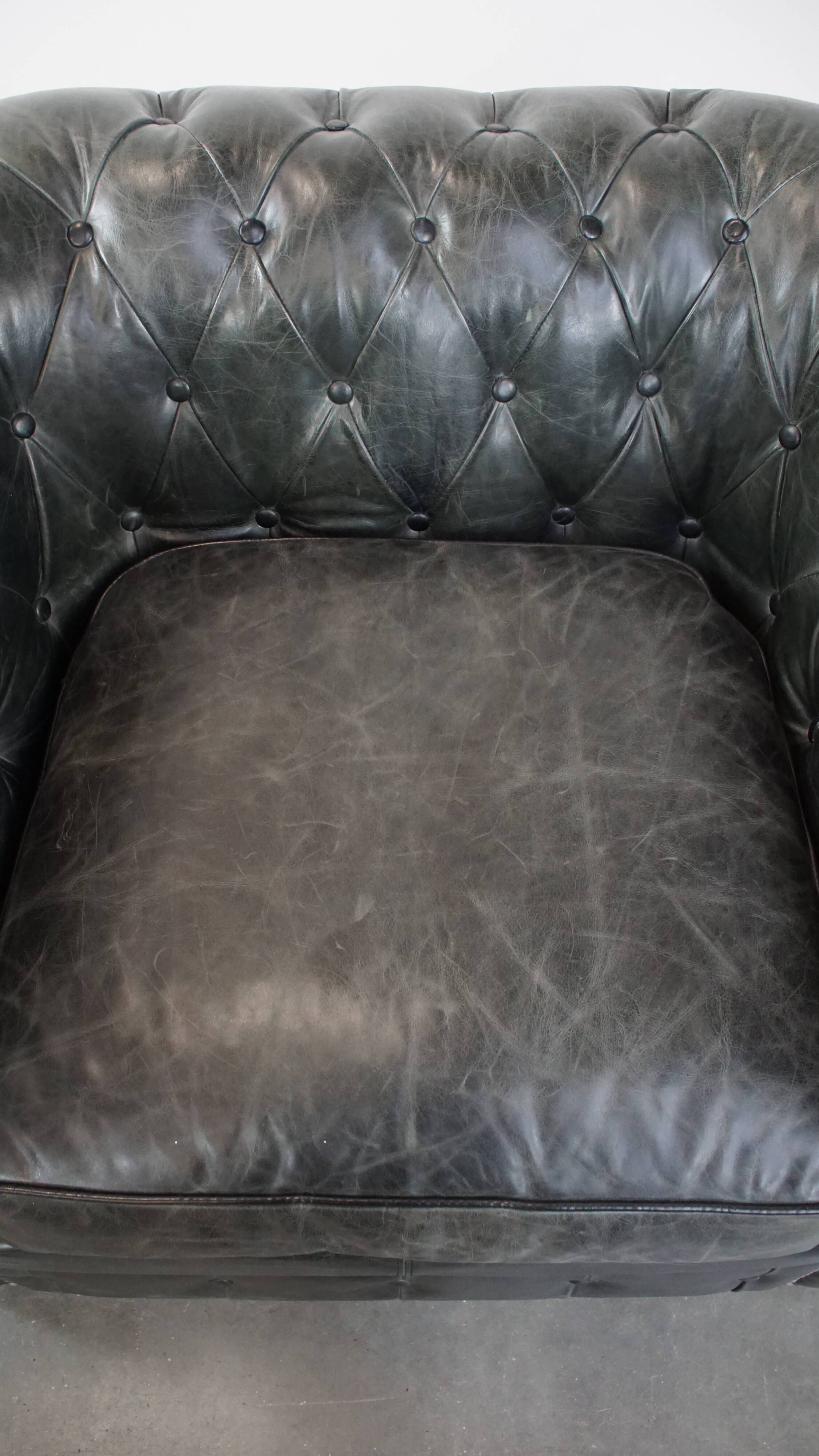 Black Chesterfield armchair made of grained cowhide leather