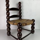 Brutalist wood turned bobbin low rush chair n the style of Charles Dudouyt