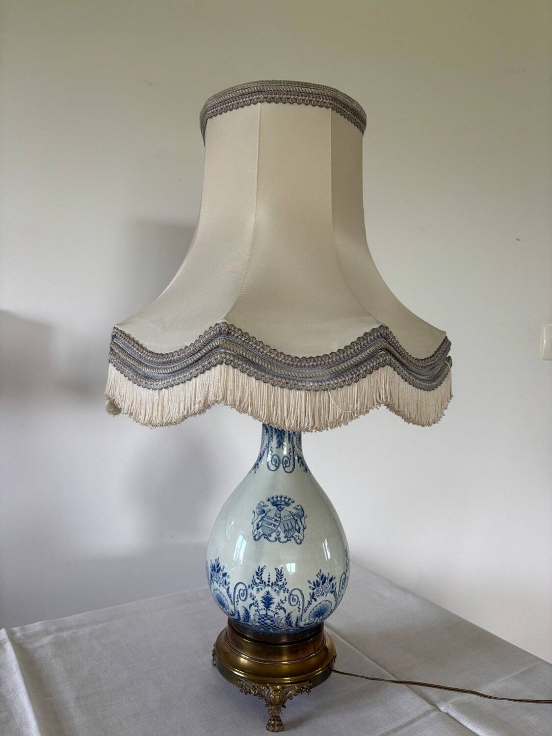19th-century blue grand feu faience lamp, tripod bronze, fringed lampshade.