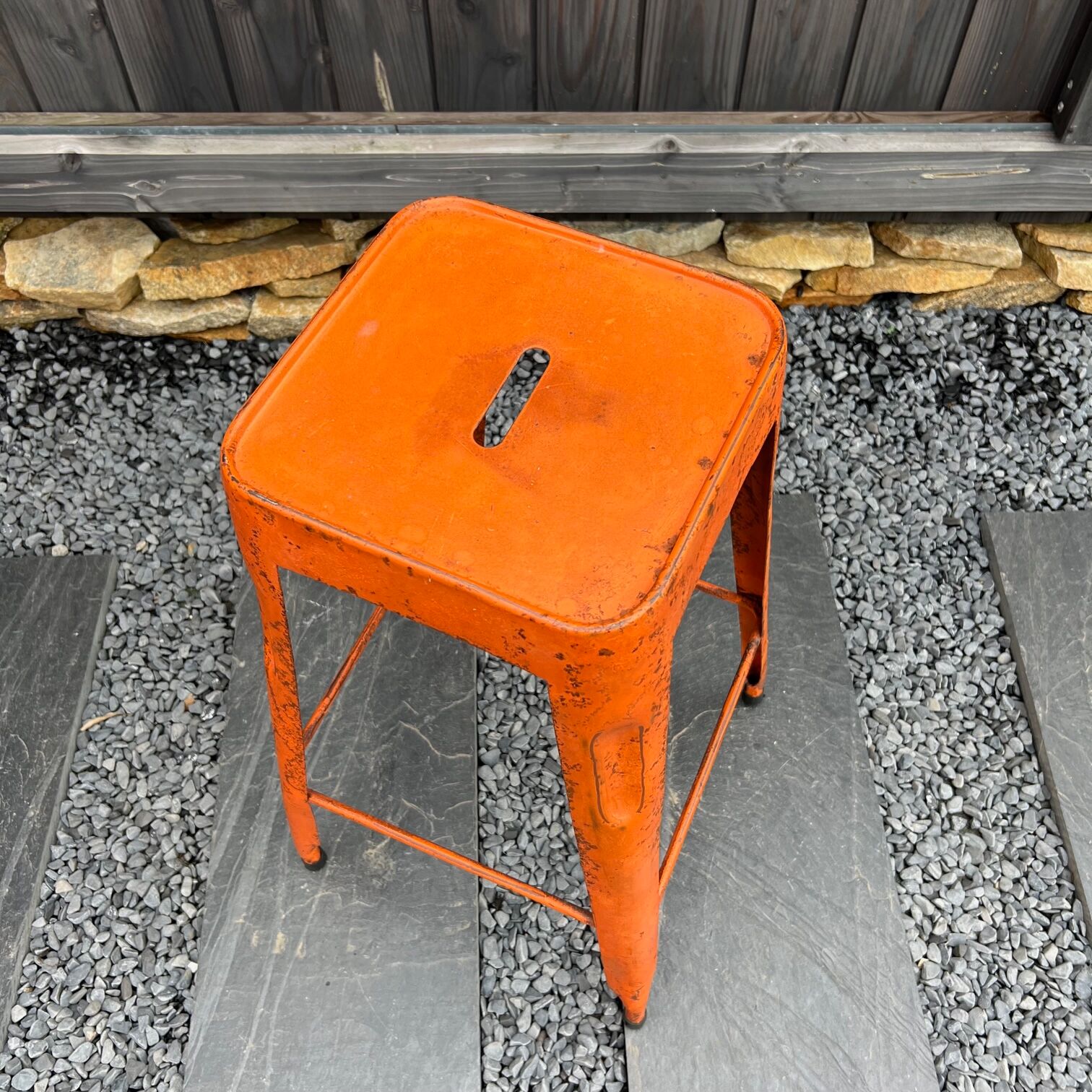 Orange metal workshop stool