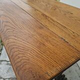 Solid oak bistro table with a cast iron base, signed.