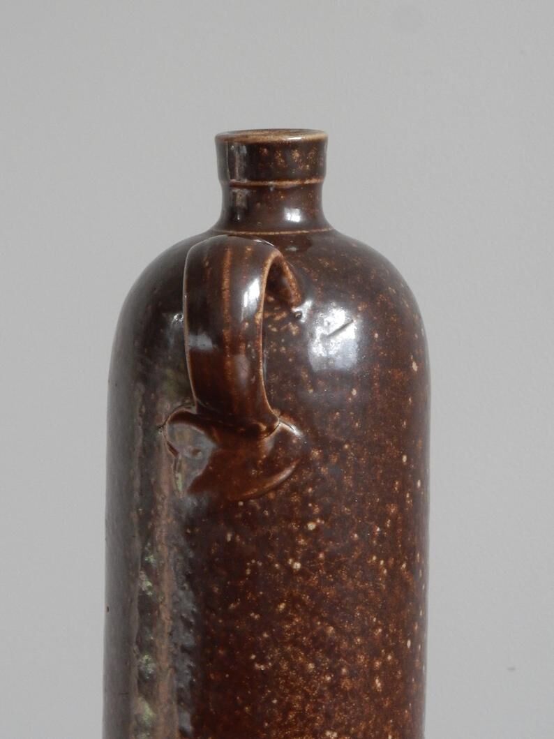 Enamelled brown sandstone bottle with handle
