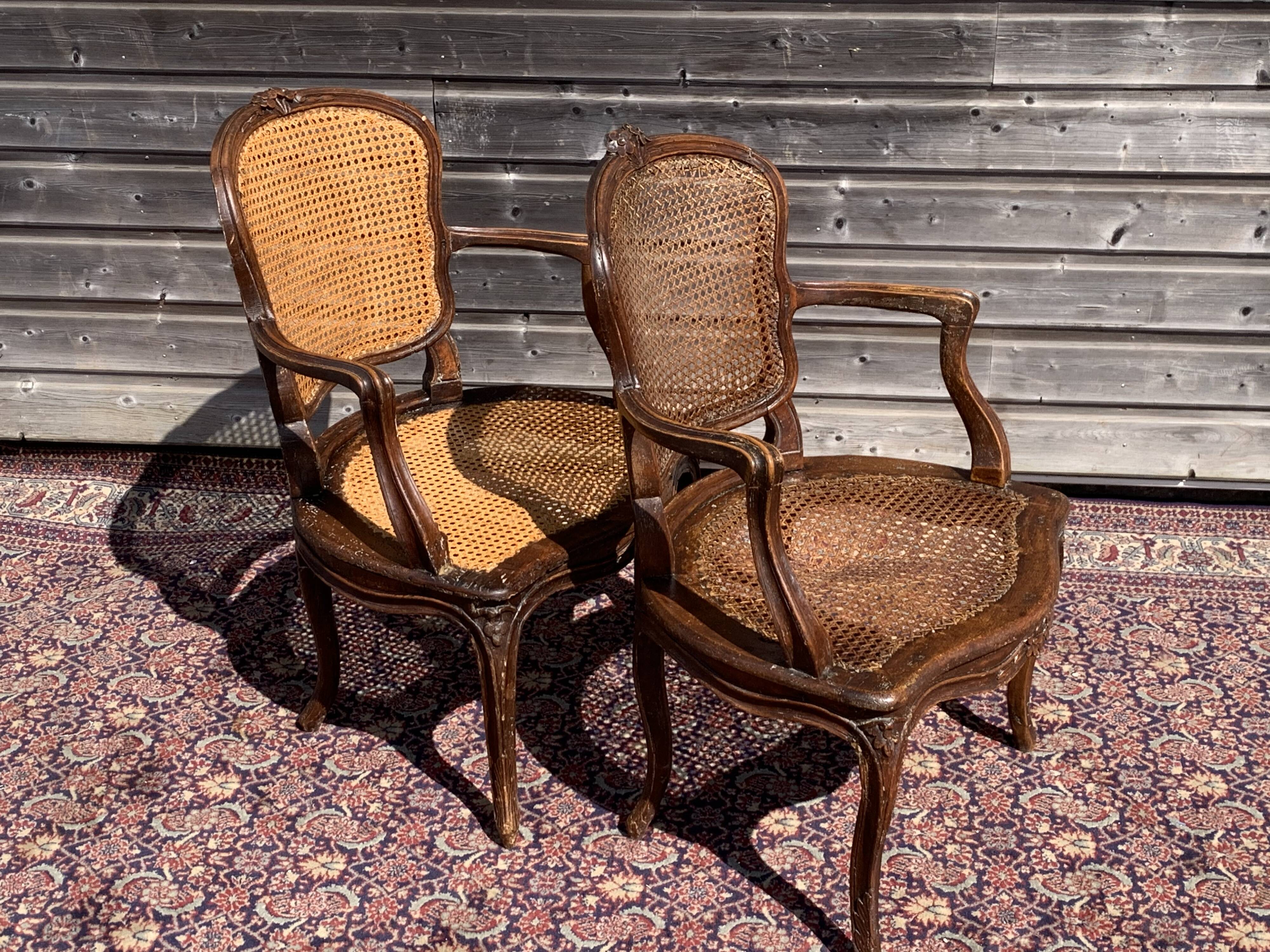 Pair of caned convertible armchairs Louis XV period