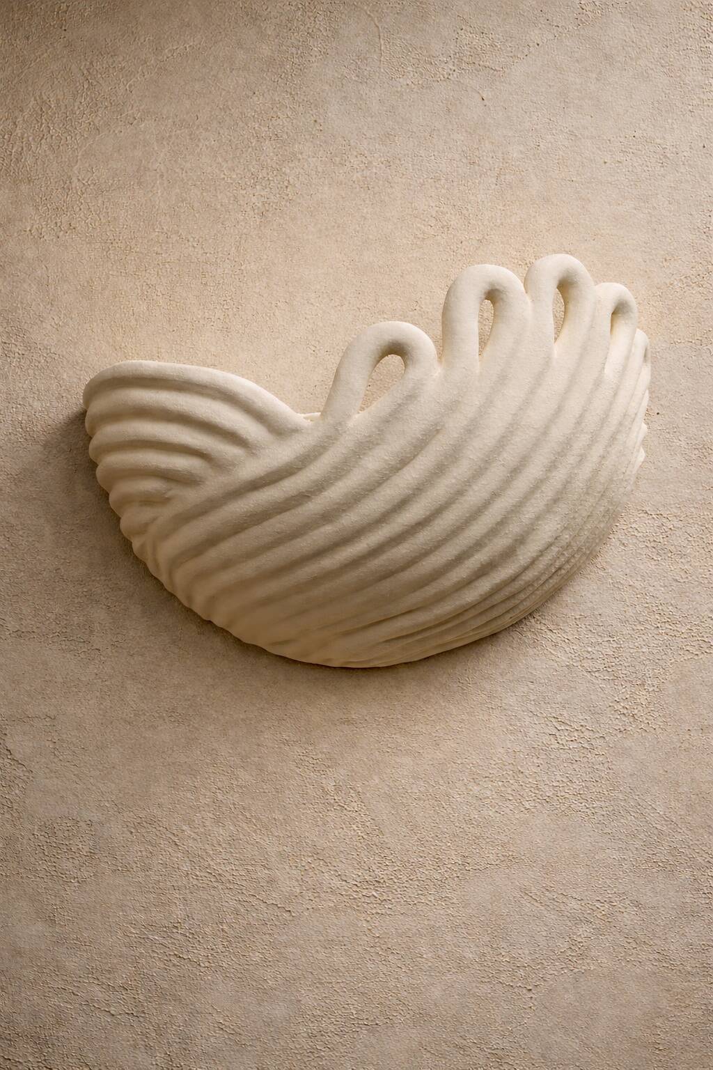 Draped ceramic wall light in a half-moon shape.