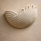 Draped ceramic wall light in a half-moon shape.