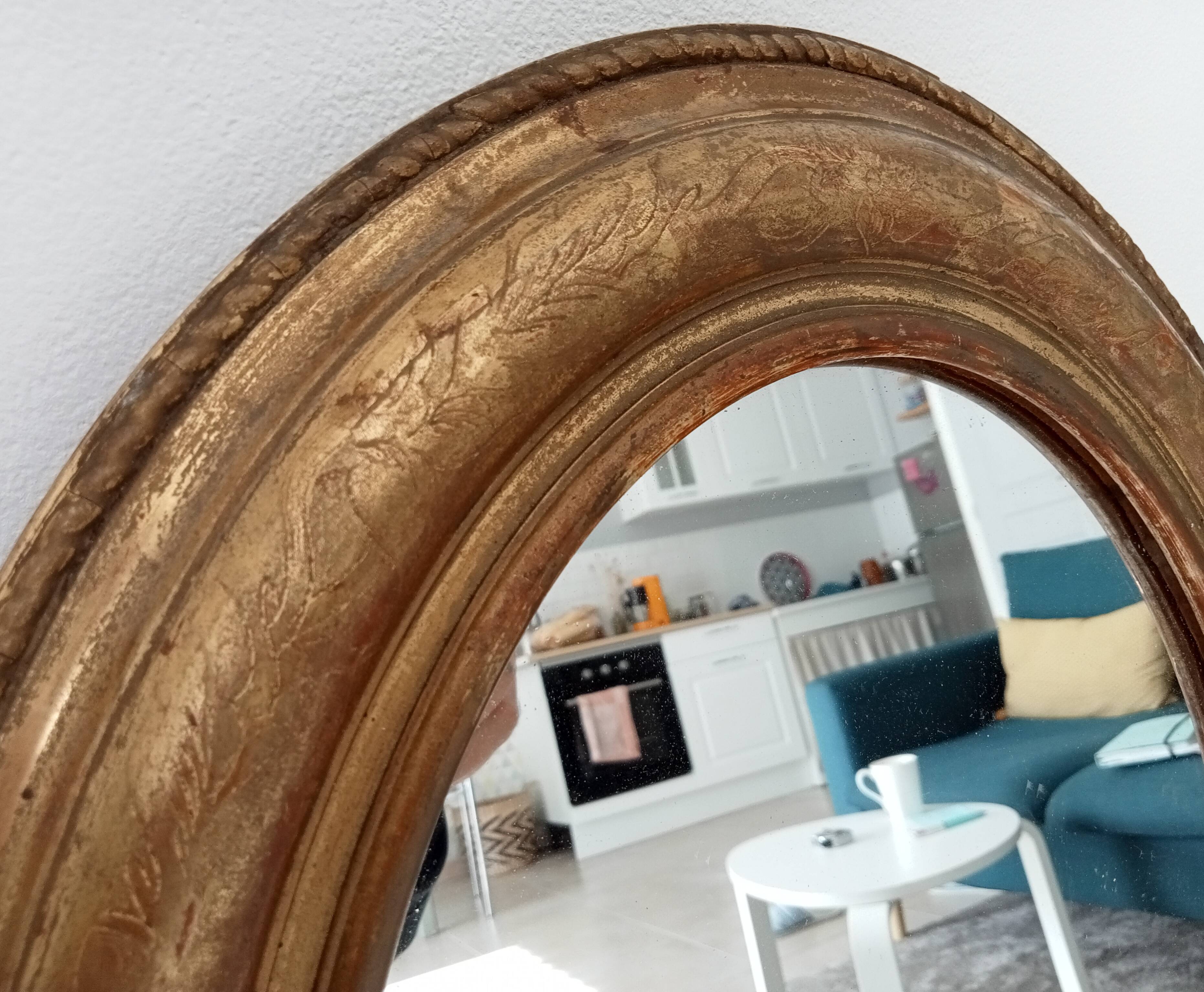 Louis Philippe 19th century oval gilded mirror in wood and stucco