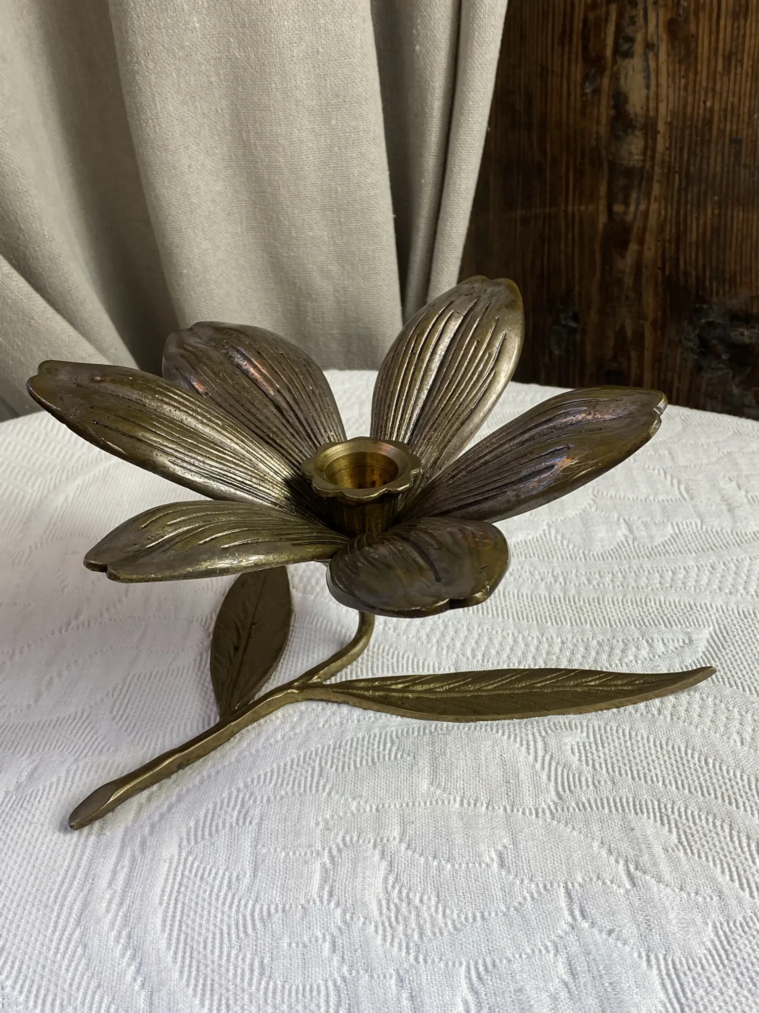 Flower candlestick and removable ashtrays in solid brass.