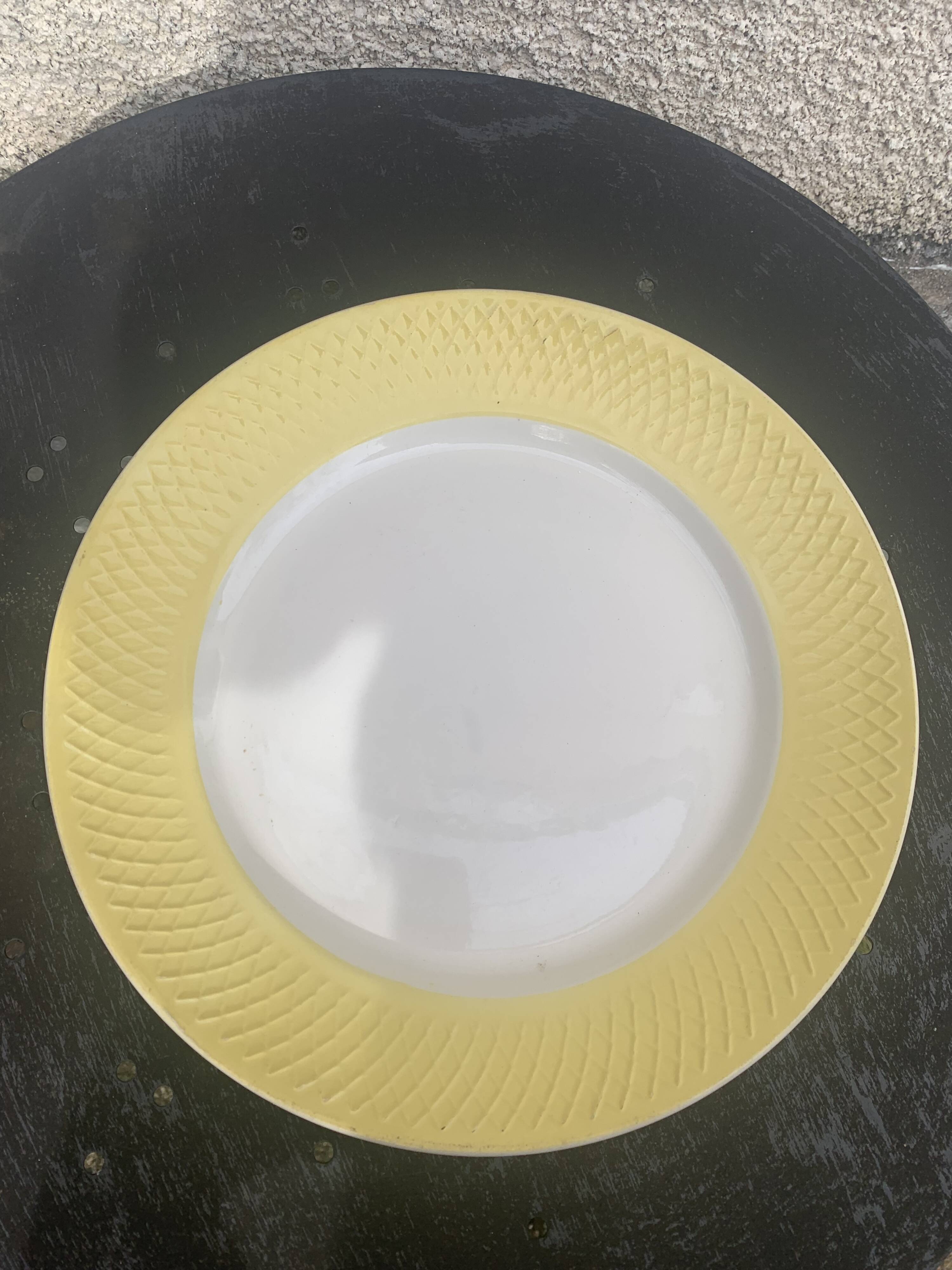 Two earthenware dishes, one hollow and one white cake dish with yellow border