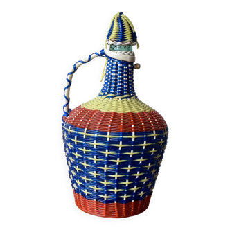 Vintage glass bottle and plastic scoubidou weaving.