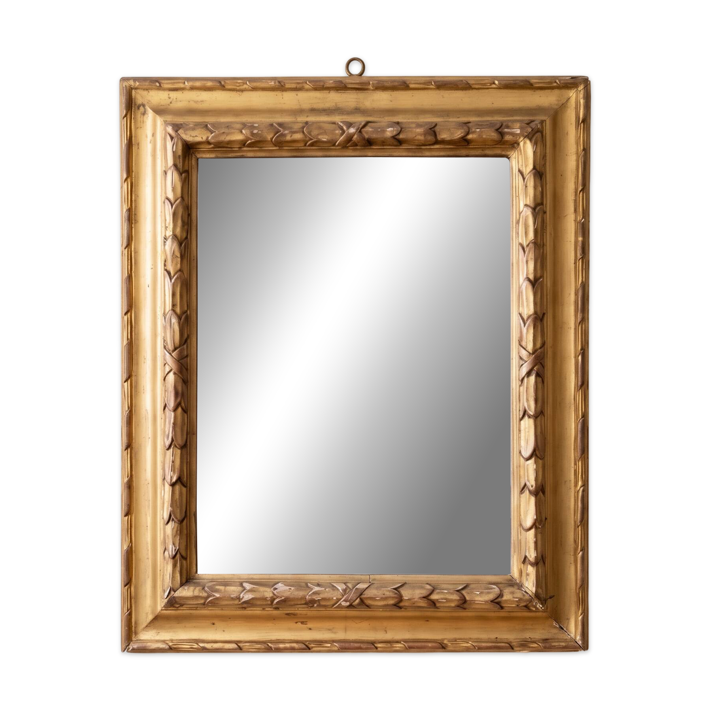 Antique wall mirror with a carved gilded frame featuring leaf motifs.