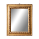 Antique wall mirror with a carved gilded frame featuring leaf motifs.