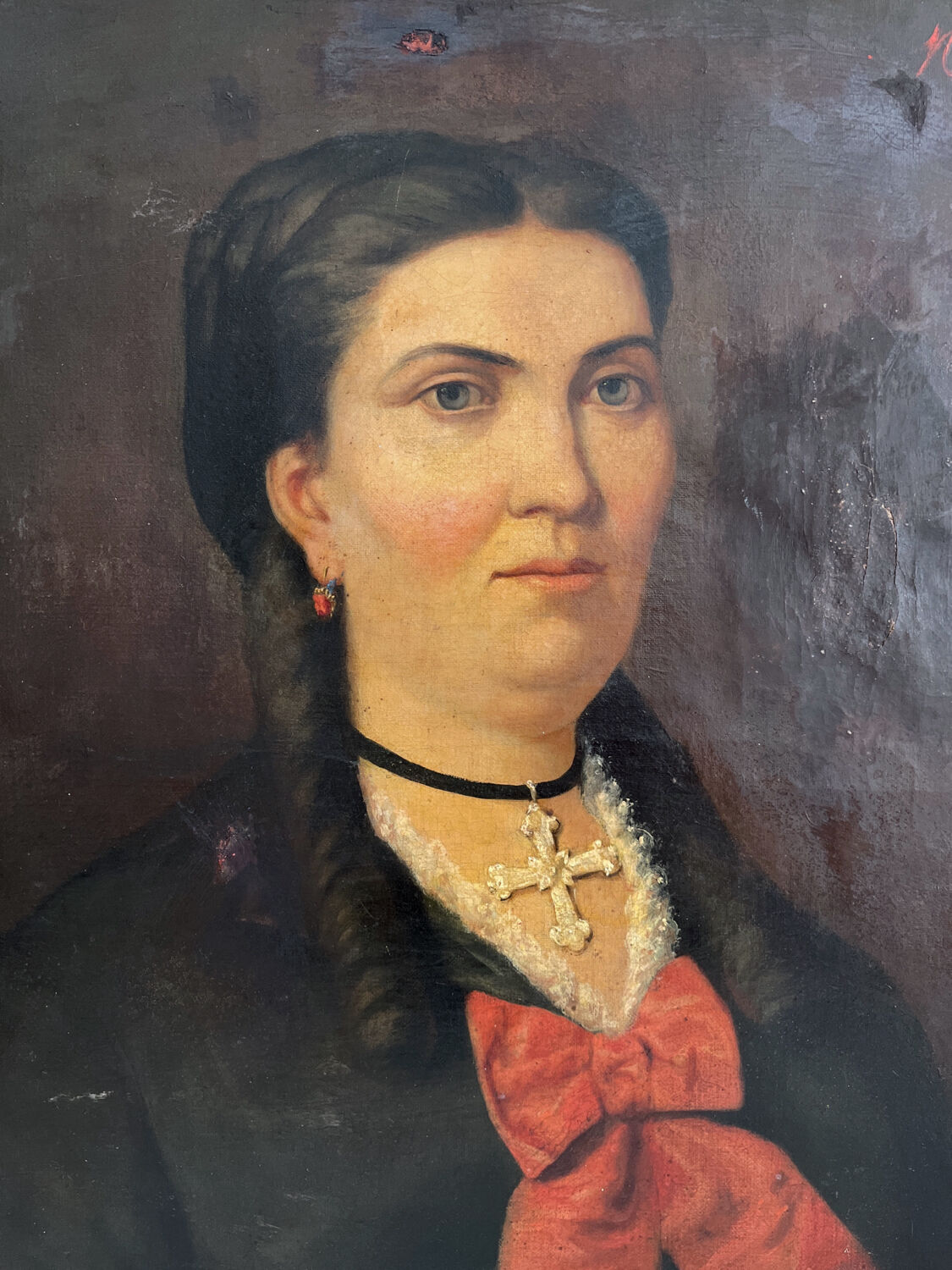Old oil painting on canvas portrait of a woman with a red bow, late 19th century