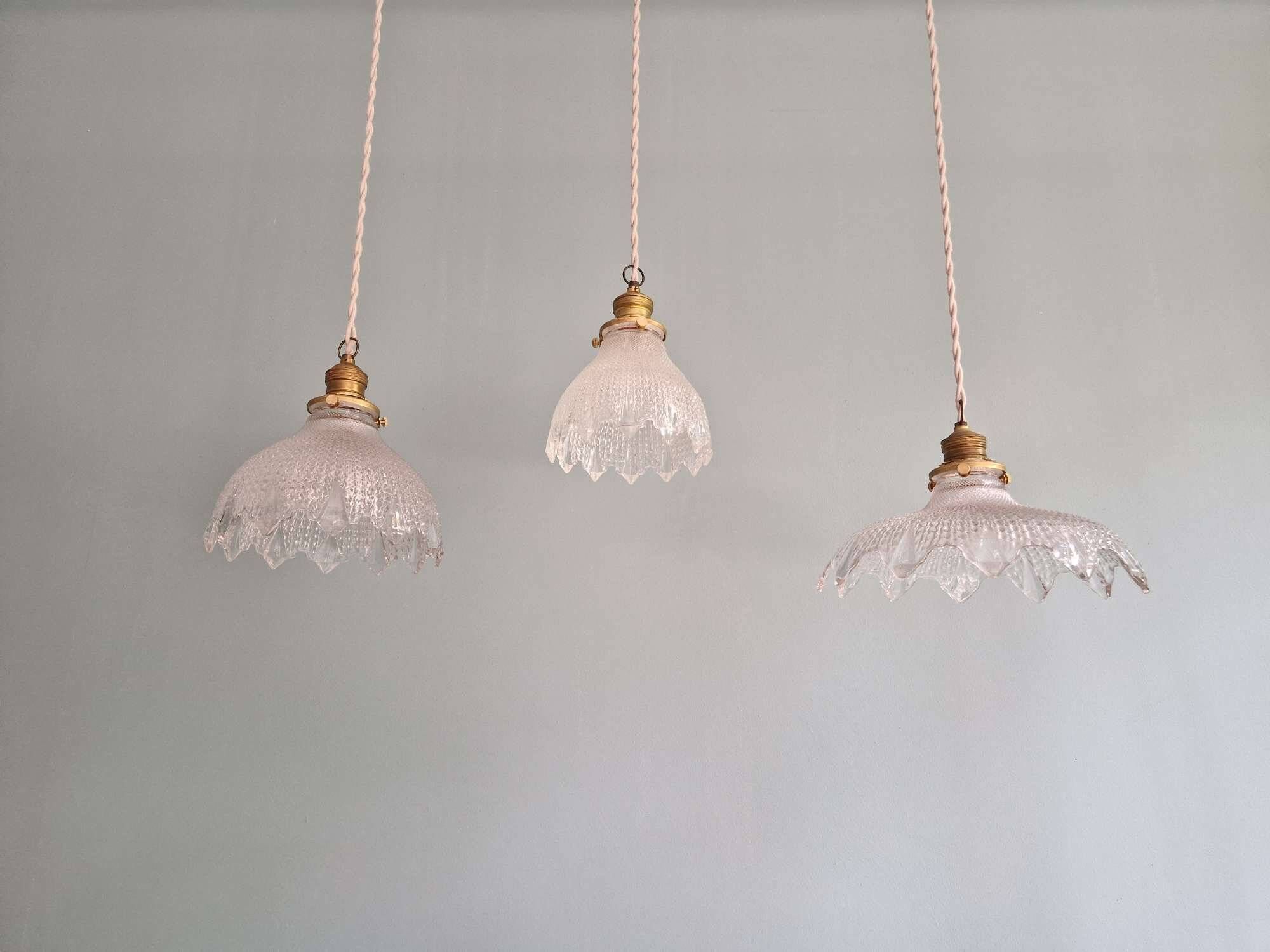 Trio of Art Deco scalloped clear glass pendant lights, 1920-30