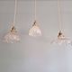 Trio of Art Deco scalloped clear glass pendant lights, 1920-30