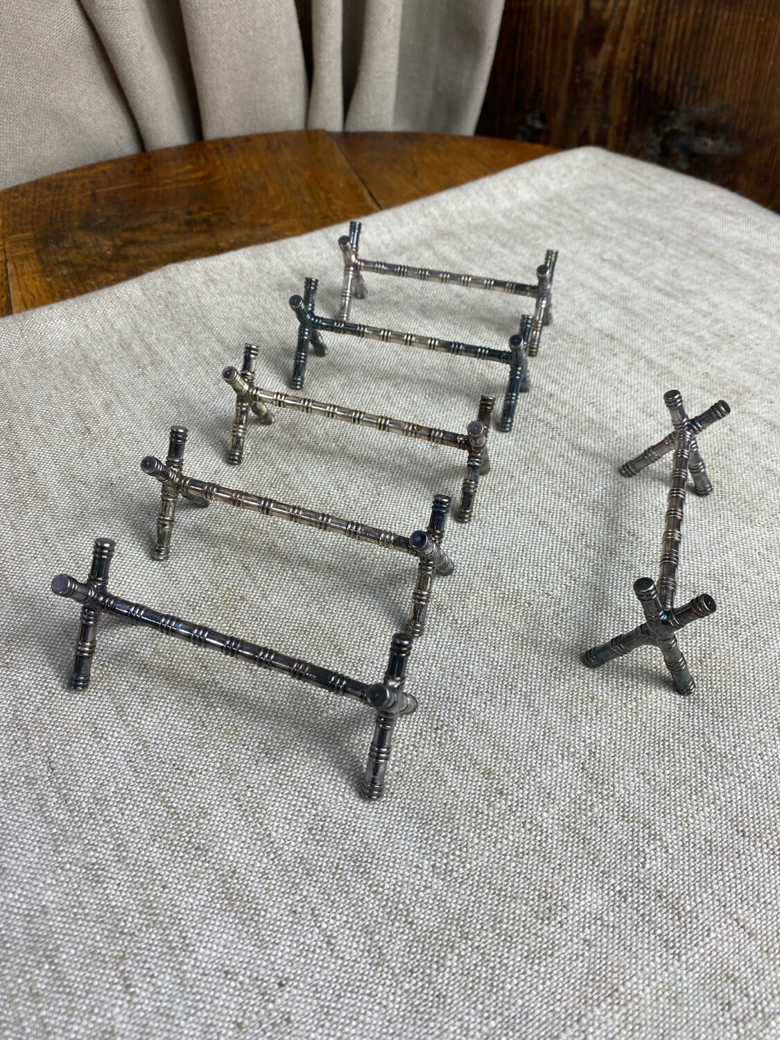 Six bamboo-patterned metal silver-plated knife rests.