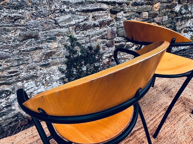 Pair of wooden and black metal chairs