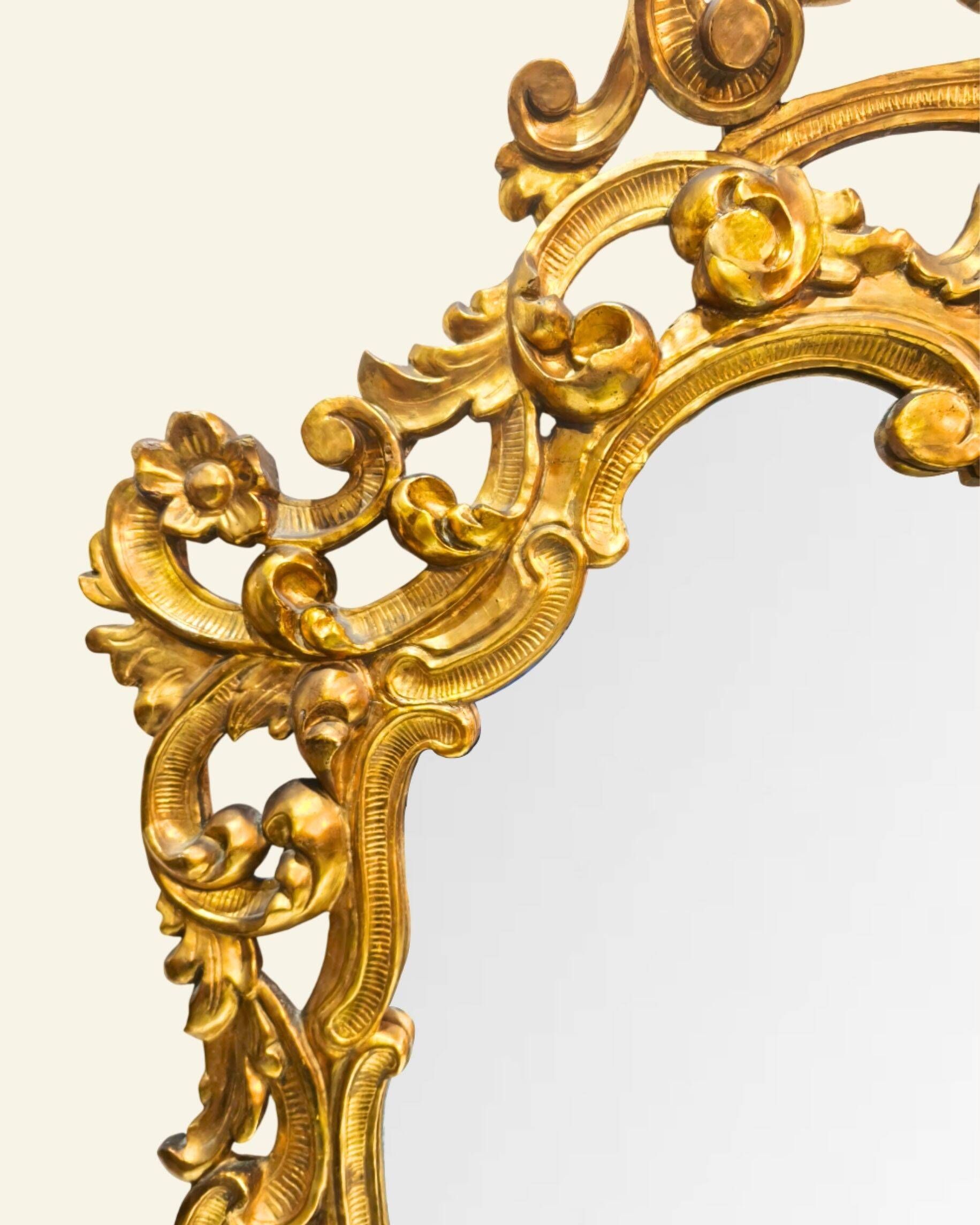 Antique wall mirror in carved and gilded wood, baroque style, 140 × 115 cm