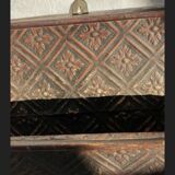 Hammered leather wall mail holder on wood.