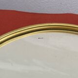 Round mirror in gold metal