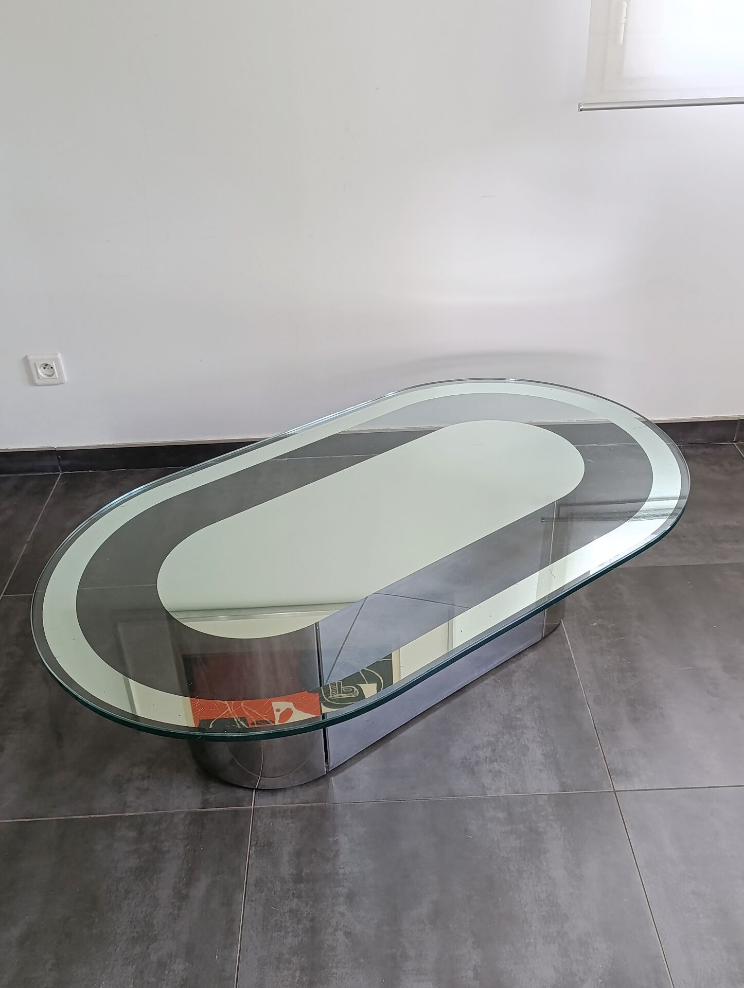 Vintage coffee table with glass and chrome metal.
