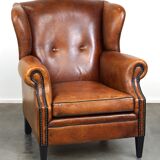 Sheepskin leather wingback armchair, with nails and black piping