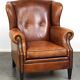 Sheepskin leather wingback armchair, with nails and black piping