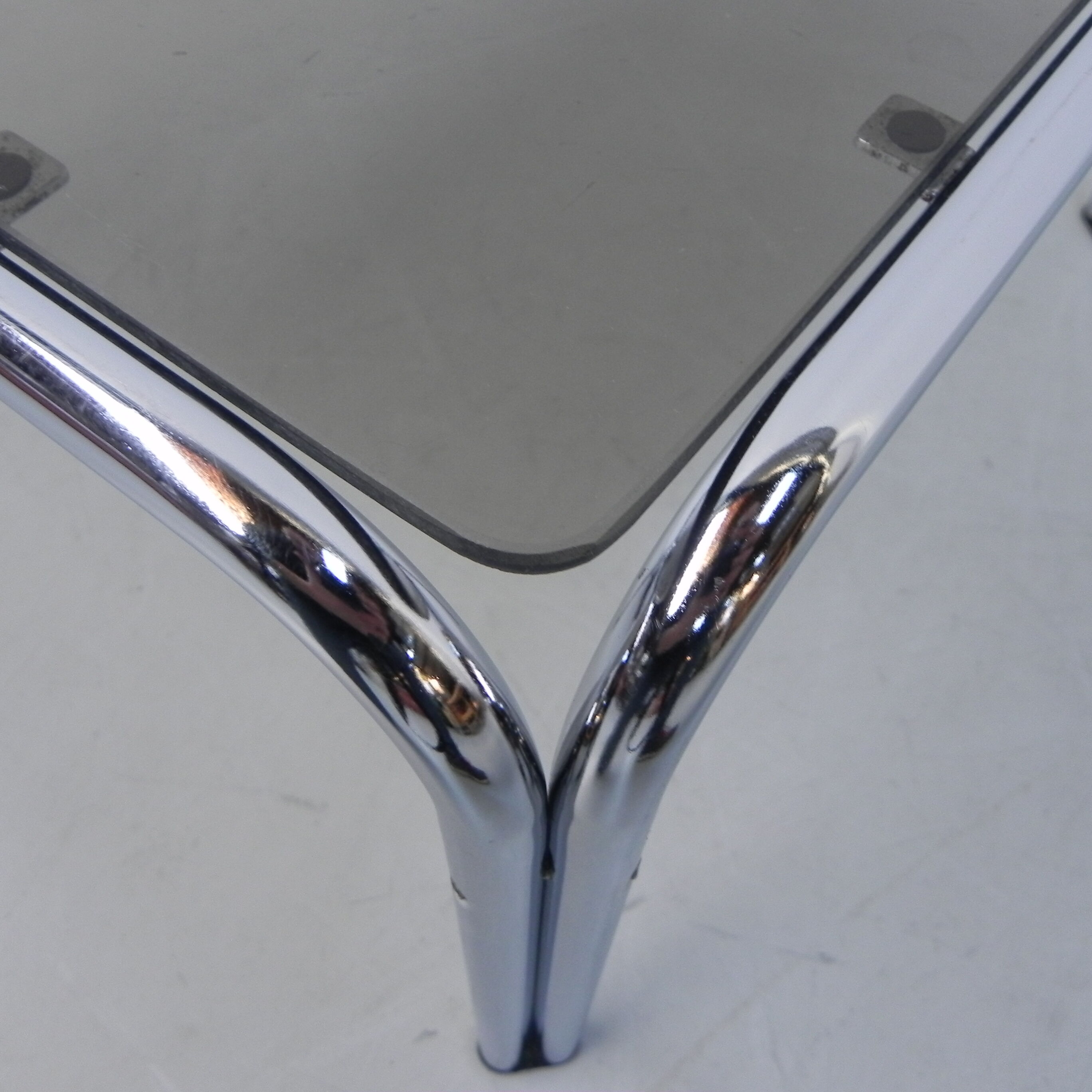 Coffee table with smoked glass top in chromed frame