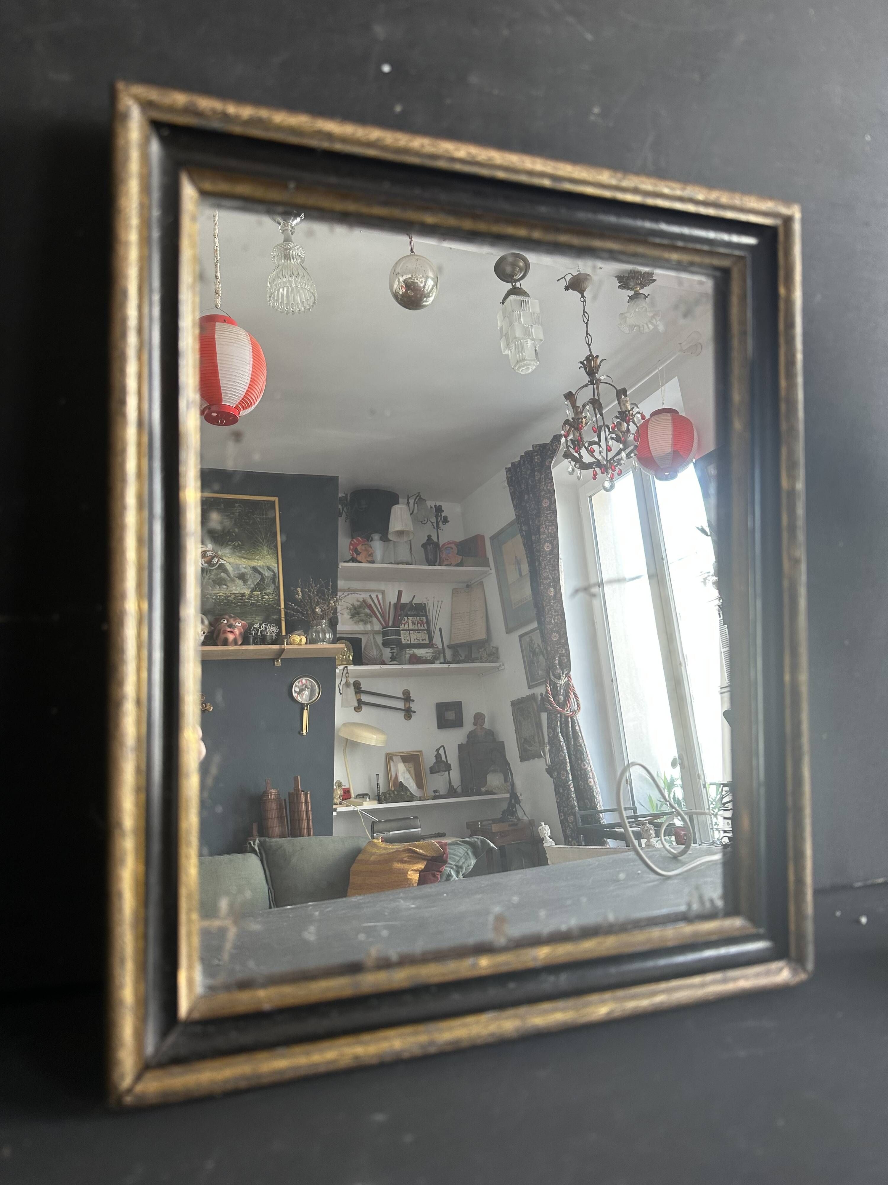 Miroir Napoléon III en bois noir et doré, XIXe siècle