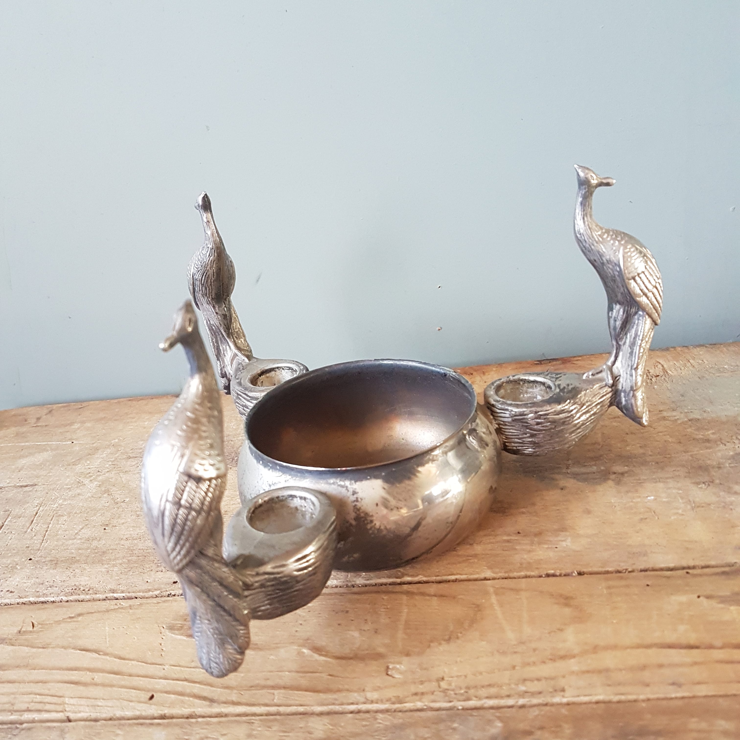 Old silver metal candlestick shelled peacocks