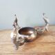 Old silver metal candlestick shelled peacocks