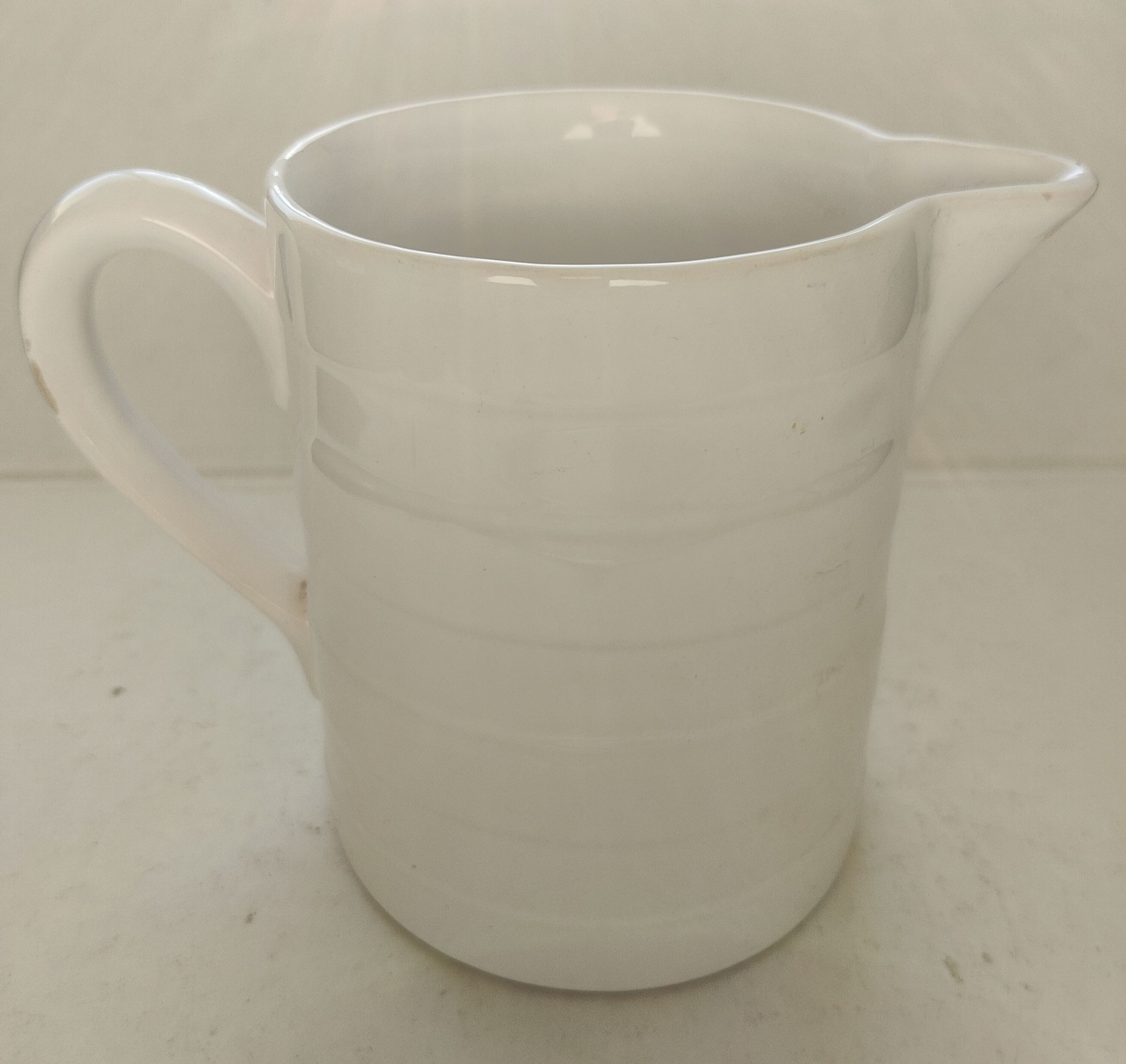 Antique white ceramic pitcher