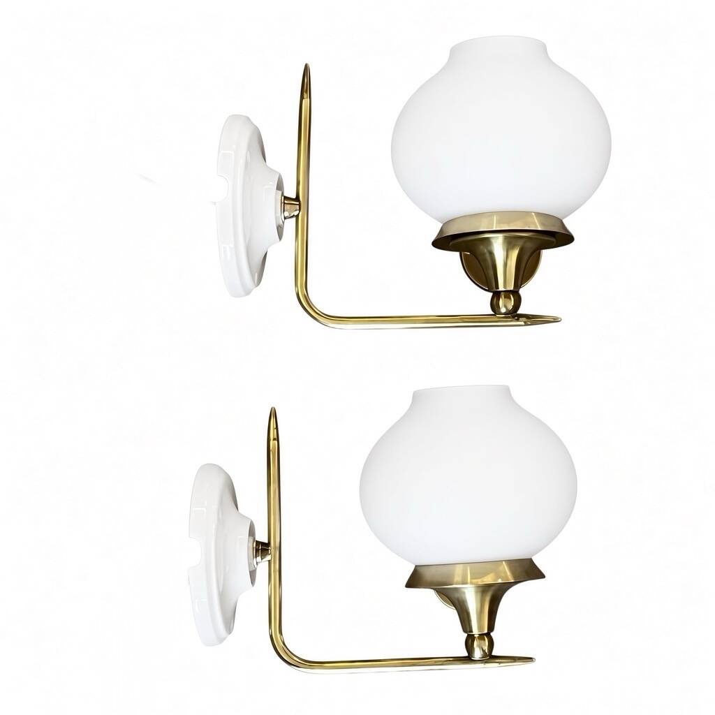 Pair of vintage wall sconces in brass with white glass globe shades.