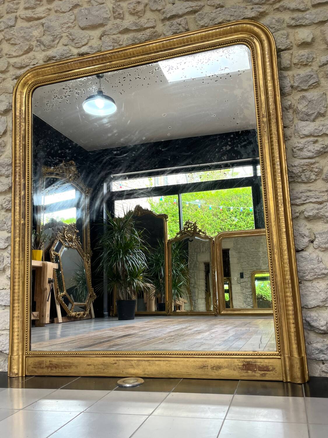 Louis-Philippe mantel mirror 133cm/115.5cm beaded gilded with gold leaf geometric decoration, late 19th century, heavily pitted and scratched glass, parquet on the back.