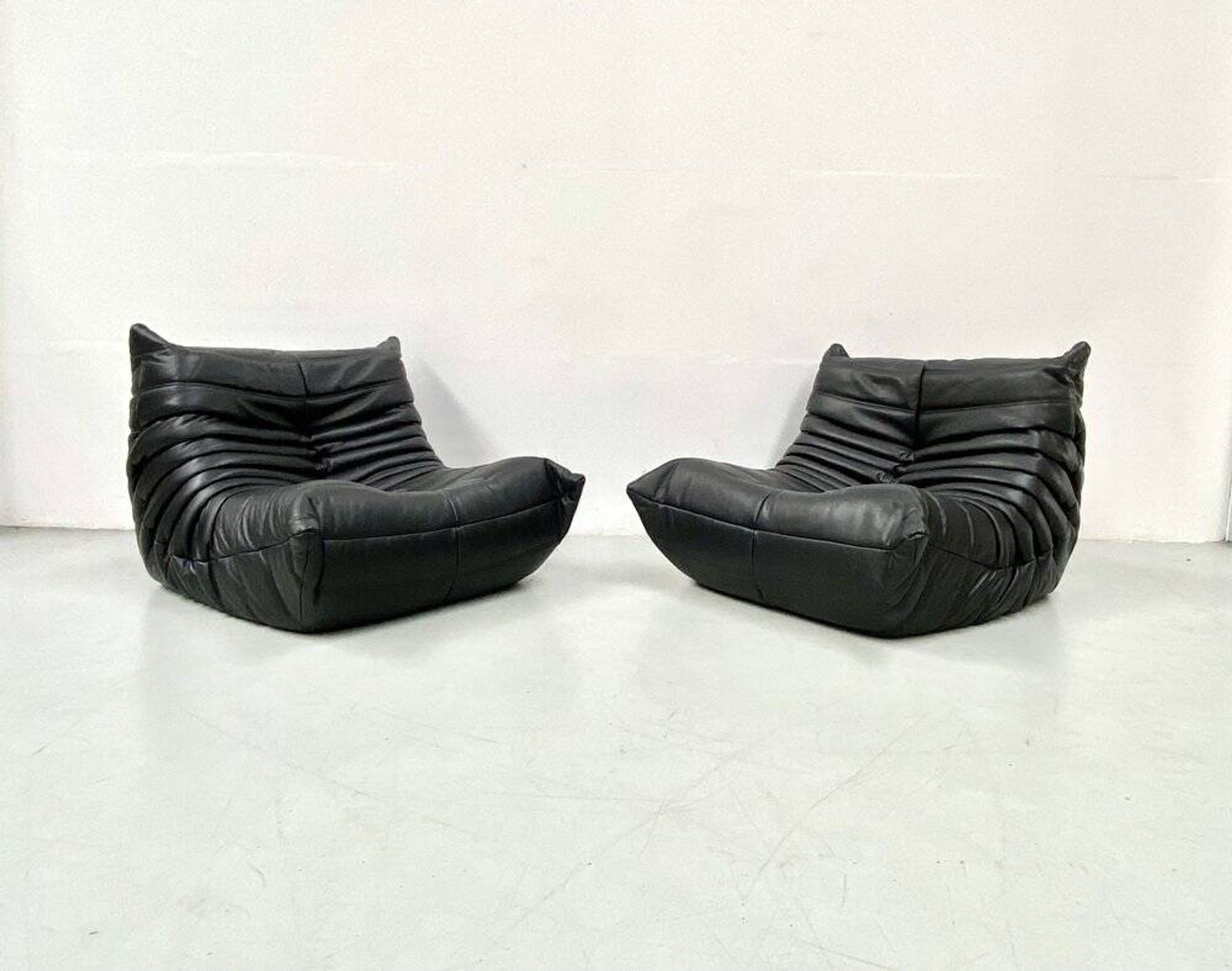 Togo lounge chairs in black leather attributed to Michel Ducaroy for Ligne Roset, set of 2