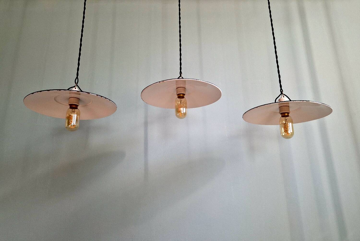 Three industrial suspensions in black enamelled sheet metal.