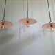 Three industrial suspensions in black enamelled sheet metal.